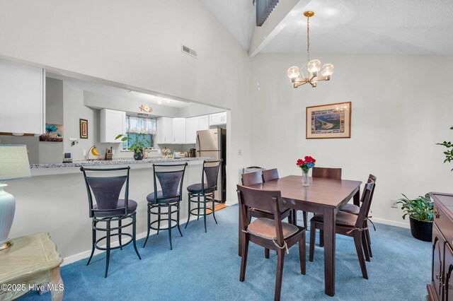 728 Azalea Dr Unit 426, Hampstead, NC 28443 - dining space featuring carpet flooring, a high ceiling, a chandelier, and baseboards