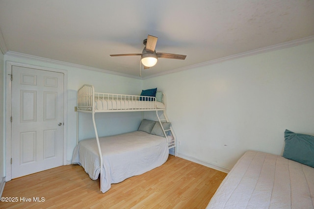 909 Carolina Beach Ave N Unit 2B, Carolina Beach, NC 28428 - bedroom featuring wood finished floors, crown molding, a ceiling fan, and baseboards