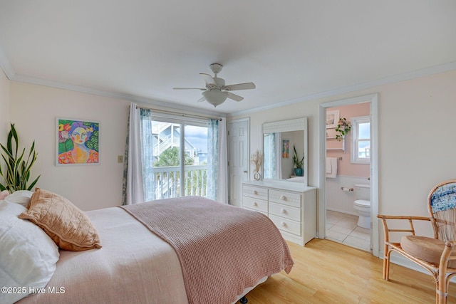 909 Carolina Beach Ave N Unit 2B, Carolina Beach, NC 28428 - bedroom with multiple windows, access to exterior, ornamental molding, ensuite bath, and light wood finished floors