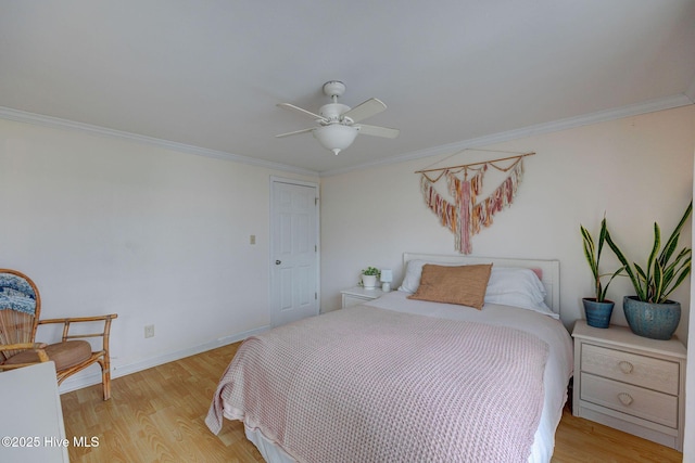 909 Carolina Beach Ave N Unit 2B, Carolina Beach, NC 28428 - bedroom featuring light wood-style floors, crown molding, a ceiling fan, and baseboards