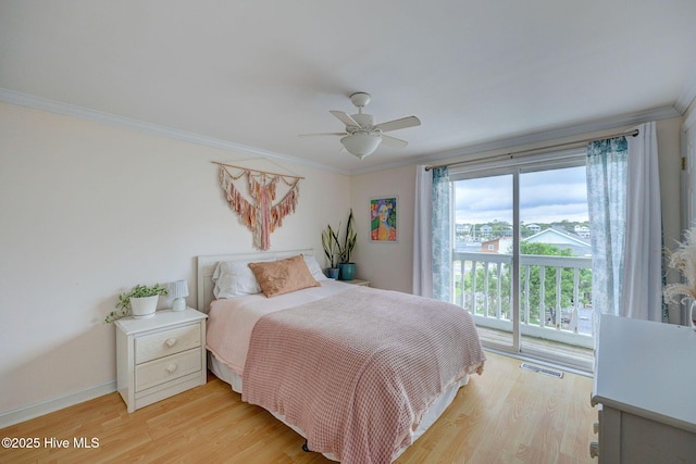 909 Carolina Beach Ave N Unit 2B, Carolina Beach, NC 28428 - bedroom featuring access to exterior, ornamental molding, light wood-style flooring, ceiling fan, and baseboards