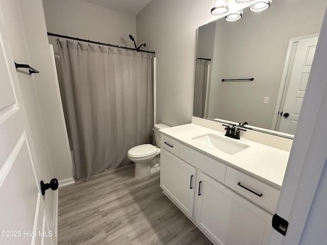 8288 Paramount Pt, Winnabow, NC 28479 - full bath featuring vanity, toilet, wood finished floors, and curtained shower