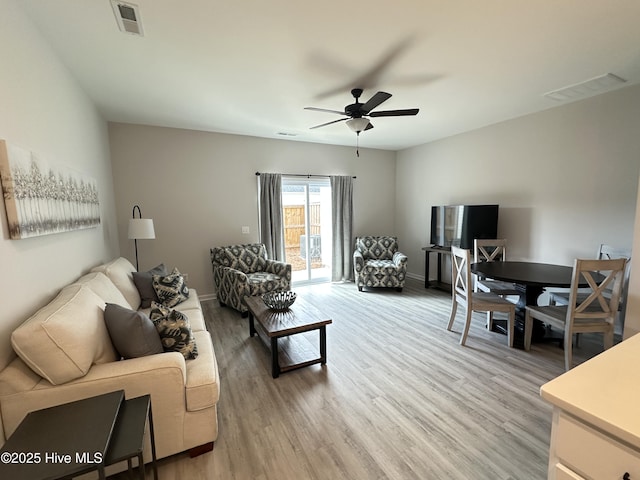 8288 Paramount Pt, Winnabow, NC 28479 - living room featuring a ceiling fan, light wood-style flooring, and baseboards