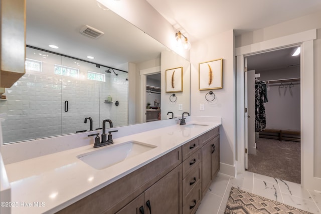 1004 Fawn Valley Way, Wilmington, NC 28409 - full bathroom featuring double vanity, a walk in closet, a stall shower, marble finish floors, and recessed lighting
