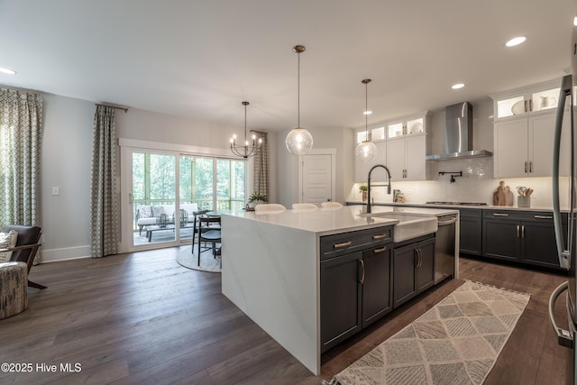 1004 Fawn Valley Way, Wilmington, NC 28409 - kitchen featuring wall chimney range hood, stainless steel appliances, light countertops, decorative backsplash, and glass insert cabinets