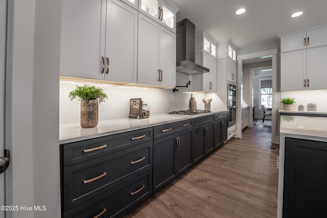 1004 Fawn Valley Way, Wilmington, NC 28409 - kitchen with wall chimney range hood, light countertops, white cabinetry, wood finished floors, and tasteful backsplash