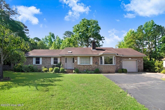 102 Trollingwood Dr, Goldsboro, NC 27534 - ranch-style home featuring a garage, asphalt driveway, a chimney, brick siding, and a front yard