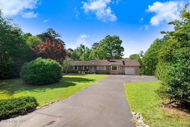 102 Trollingwood Dr, Goldsboro, NC 27534 - ranch-style house featuring a garage, driveway, and a front yard