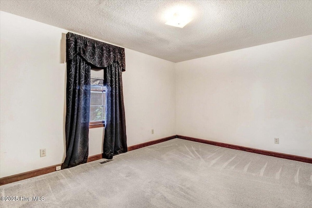 102 Trollingwood Dr, Goldsboro, NC 27534 - spare room featuring light colored carpet, a textured ceiling, and baseboards