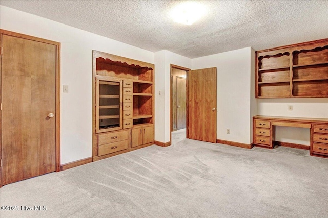 102 Trollingwood Dr, Goldsboro, NC 27534 - unfurnished bedroom featuring a textured ceiling, light carpet, and baseboards
