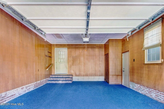 102 Trollingwood Dr, Goldsboro, NC 27534 - garage featuring wood walls and a garage door opener