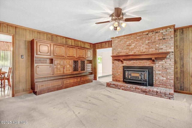 102 Trollingwood Dr, Goldsboro, NC 27534 - unfurnished living room with wooden walls, healthy amount of natural light, a ceiling fan, light colored carpet, and baseboards