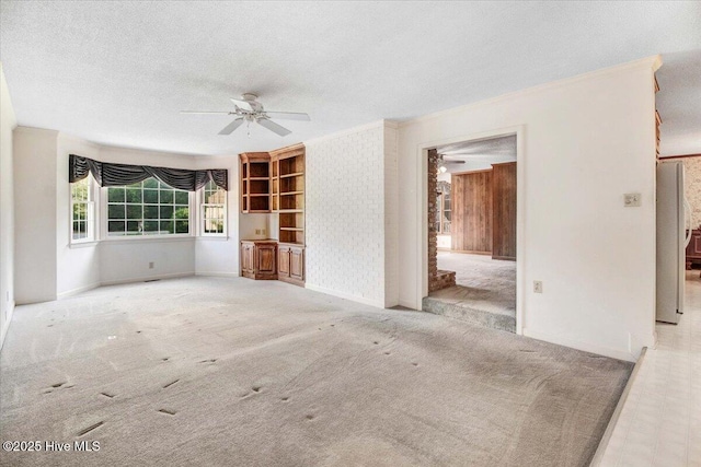 102 Trollingwood Dr, Goldsboro, NC 27534 - unfurnished living room featuring ceiling fan, ornamental molding, a textured ceiling, baseboards, and carpet flooring