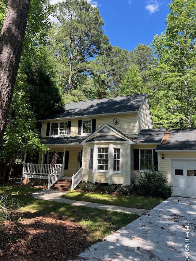 165 Sandhurst Pl, Southern Pines, NC 28387 - view of front facade featuring an attached garage, covered porch, and concrete driveway