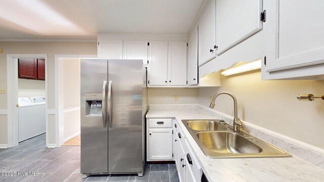 165 Sandhurst Pl, Southern Pines, NC 28387 - kitchen with stainless steel fridge, a sink, separate washer and dryer, white cabinets, and crown molding