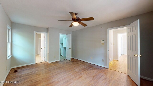 165 Sandhurst Pl, Southern Pines, NC 28387 - unfurnished bedroom featuring light wood-style floors, baseboards, ensuite bath, and a ceiling fan