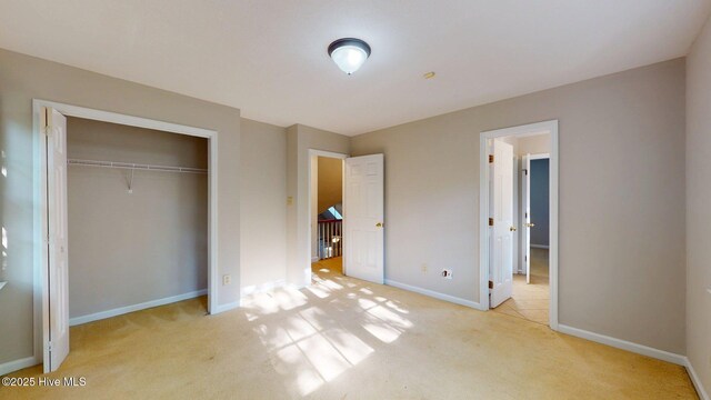 165 Sandhurst Pl, Southern Pines, NC 28387 - unfurnished bedroom featuring light carpet, baseboards, and a closet