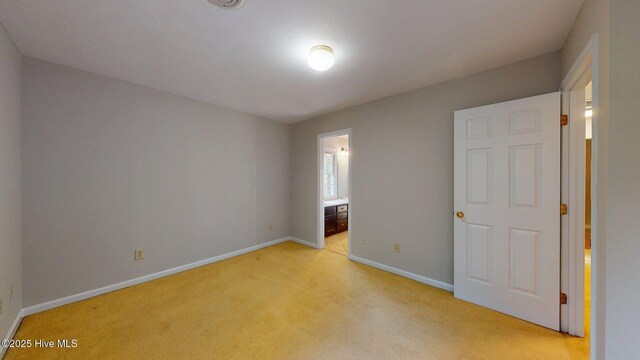 165 Sandhurst Pl, Southern Pines, NC 28387 - unfurnished bedroom with light colored carpet, baseboards, and connected bathroom