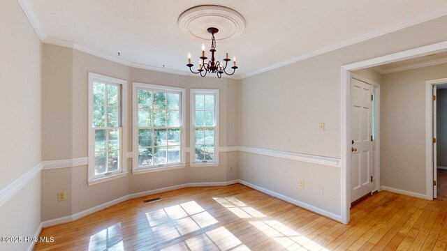 165 Sandhurst Pl, Southern Pines, NC 28387 - spare room featuring light wood-style floors, a chandelier, baseboards, and crown molding