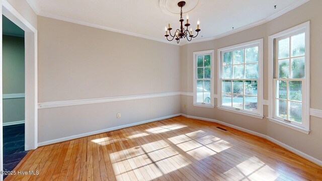165 Sandhurst Pl, Southern Pines, NC 28387 - spare room featuring light wood-type flooring, a chandelier, baseboards, and crown molding