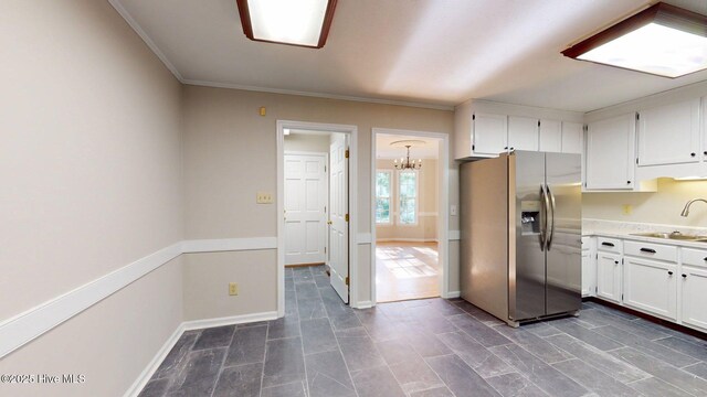 165 Sandhurst Pl, Southern Pines, NC 28387 - kitchen with stainless steel fridge, a sink, white cabinets, and crown molding
