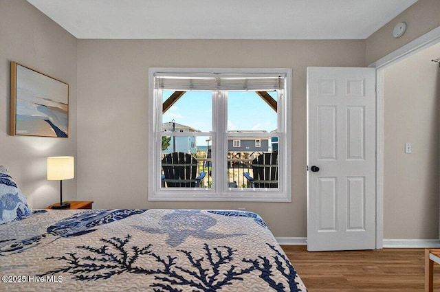 1116 E Beach Dr, Oak Island, NC 28465 - bedroom featuring wood finished floors and baseboards