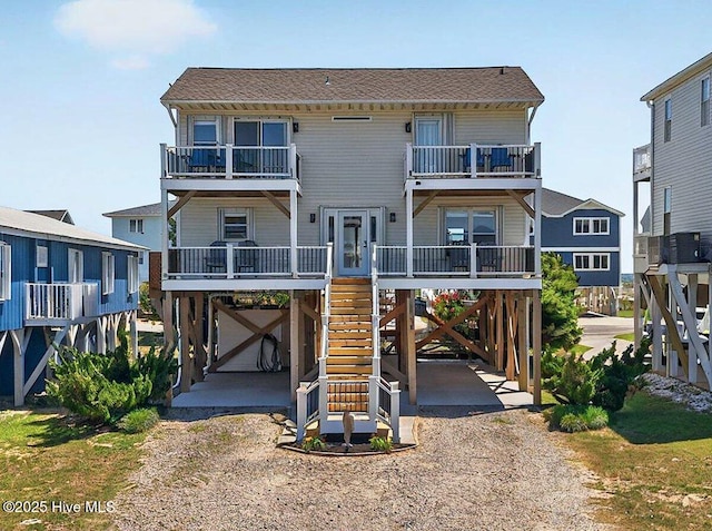1116 E Beach Dr, Oak Island, NC 28465 - coastal home with a carport and a balcony