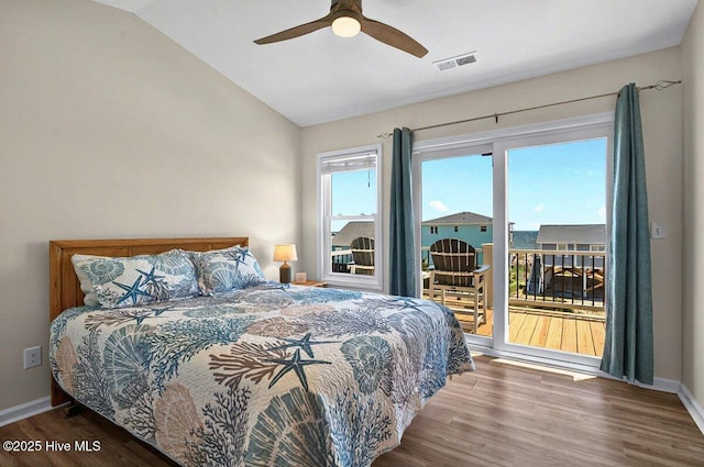 1116 E Beach Dr, Oak Island, NC 28465 - bedroom with access to exterior, vaulted ceiling, wood finished floors, and a ceiling fan
