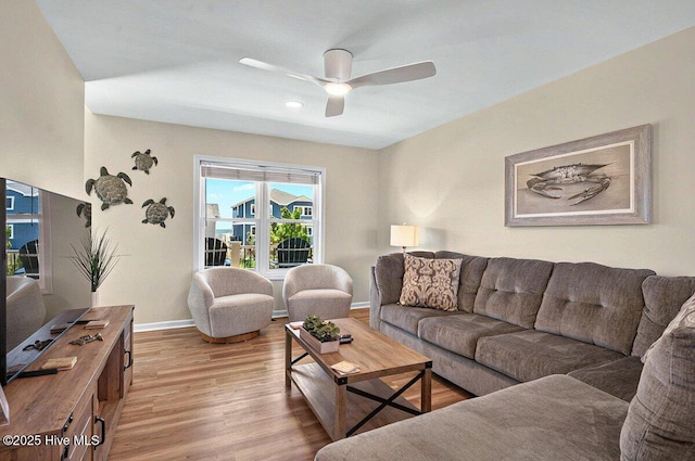 1116 E Beach Dr, Oak Island, NC 28465 - living area featuring light wood finished floors, a ceiling fan, and baseboards