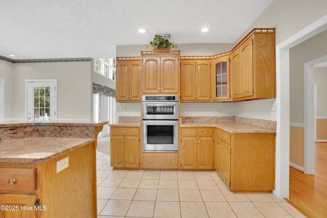 109 Country Club Dr, Rockingham, NC 28379 - kitchen with double oven, glass insert cabinets, light tile patterned flooring, recessed lighting, and light stone countertops
