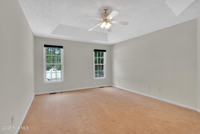 109 Country Club Dr, Rockingham, NC 28379 - unfurnished room with a raised ceiling, light colored carpet, baseboards, and a textured ceiling