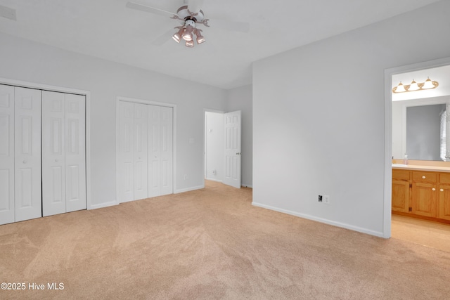 109 Country Club Dr, Rockingham, NC 28379 - unfurnished bedroom featuring light colored carpet, multiple closets, connected bathroom, and baseboards