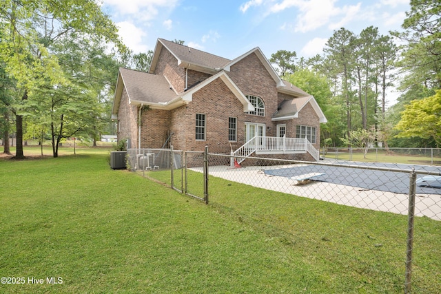 109 Country Club Dr, Rockingham, NC 28379 - back of property featuring brick siding, a patio area, cooling unit, and a wooden deck