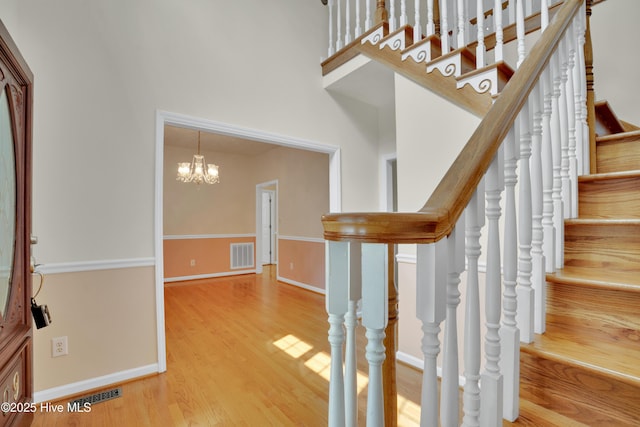 109 Country Club Dr, Rockingham, NC 28379 - stairway with wood finished floors, baseboards, and a chandelier