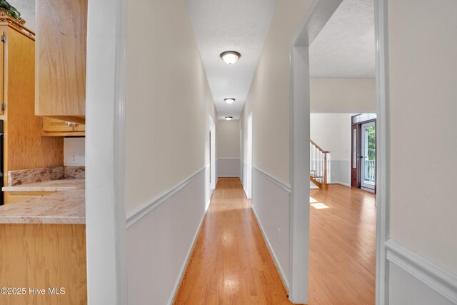 109 Country Club Dr, Rockingham, NC 28379 - corridor featuring light wood-style flooring and stairs