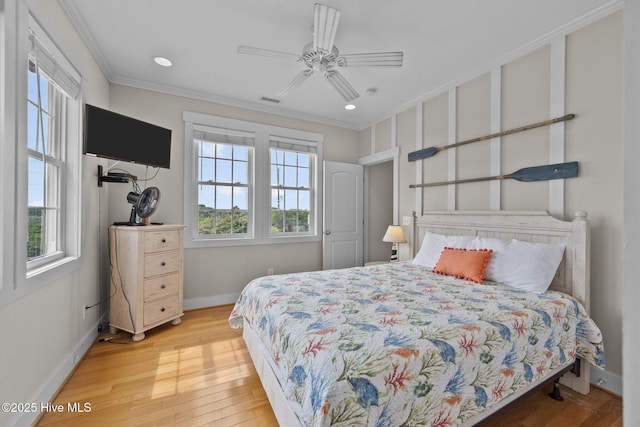 4248 Island Dr, North Topsail Beach, NC 28460 - bedroom with multiple windows, ornamental molding, wood finished floors, baseboards, and recessed lighting