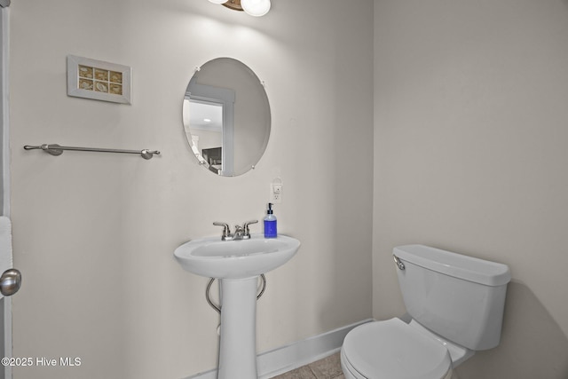 4248 Island Dr, North Topsail Beach, NC 28460 - bathroom featuring toilet, tile patterned flooring, and baseboards