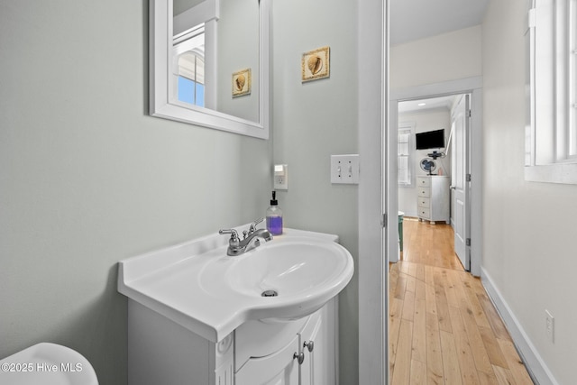 4248 Island Dr, North Topsail Beach, NC 28460 - half bath featuring vanity, wood finished floors, toilet, and baseboards