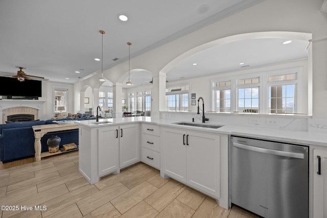 4248 Island Dr, North Topsail Beach, NC 28460 - kitchen featuring dishwasher, a sink, a ceiling fan, open floor plan, and a tiled fireplace