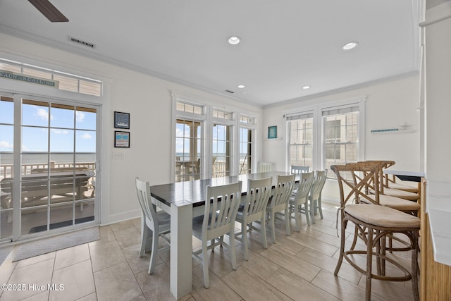 4248 Island Dr, North Topsail Beach, NC 28460 - dining space with crown molding, recessed lighting, and baseboards