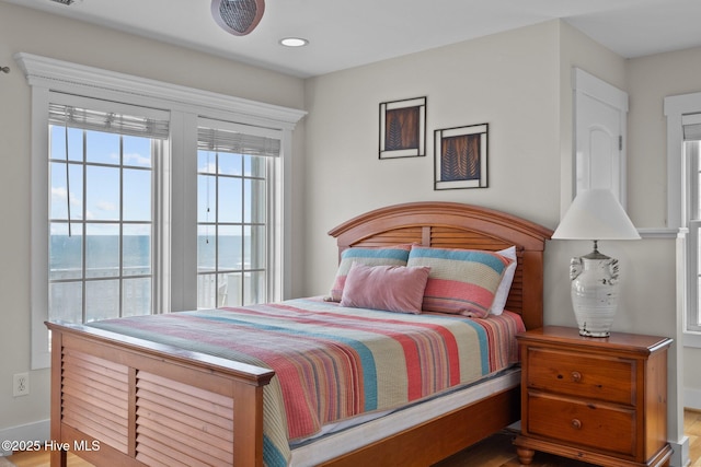 4248 Island Dr, North Topsail Beach, NC 28460 - bedroom featuring a water view, baseboards, wood finished floors, and recessed lighting