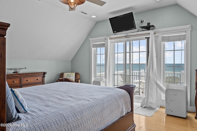 4248 Island Dr, North Topsail Beach, NC 28460 - bedroom with lofted ceiling, light wood-style flooring, access to outside, multiple windows, and recessed lighting