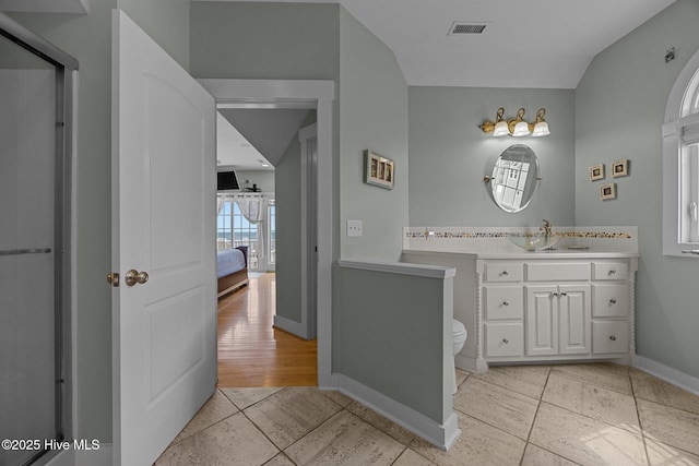 4248 Island Dr, North Topsail Beach, NC 28460 - ensuite bathroom featuring vanity, toilet, baseboards, and tile patterned floors