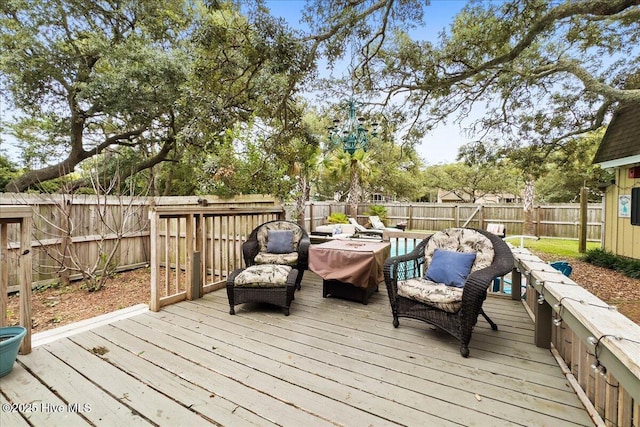 302 Mcglamery St, Oak Island, NC 28465 - wooden deck with a fenced backyard and an outdoor living space