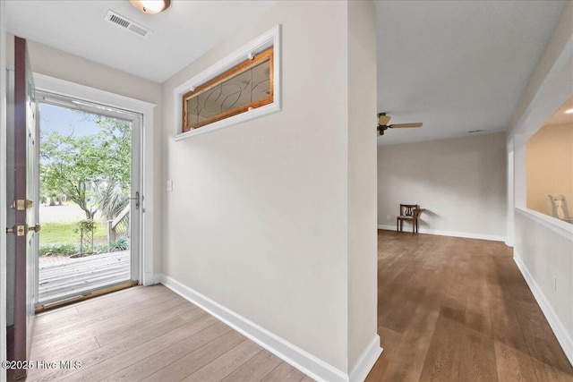 302 Mcglamery St, Oak Island, NC 28465 - doorway featuring wood finished floors, a ceiling fan, and baseboards