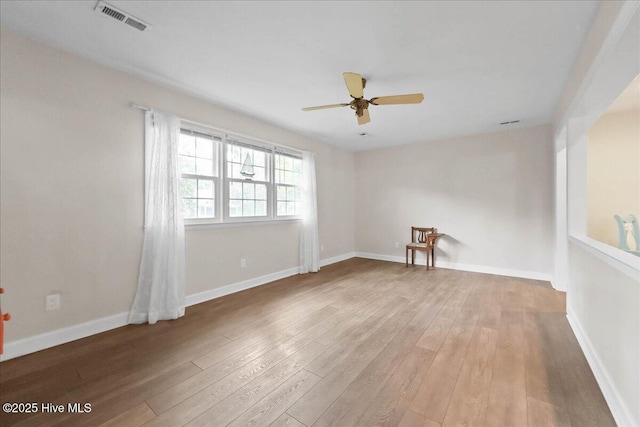302 Mcglamery St, Oak Island, NC 28465 - empty room featuring a ceiling fan, light wood finished floors, and baseboards