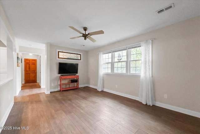302 Mcglamery St, Oak Island, NC 28465 - unfurnished living room with a ceiling fan, wood-type flooring, and baseboards