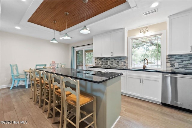 302 Mcglamery St, Oak Island, NC 28465 - kitchen with a tray ceiling, dishwasher, a sink, light wood-style flooring, and wooden ceiling
