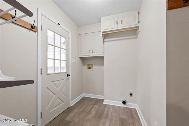 302 Mcglamery St, Oak Island, NC 28465 - laundry area featuring washer hookup, electric dryer hookup, wood finished floors, cabinet space, and baseboards
