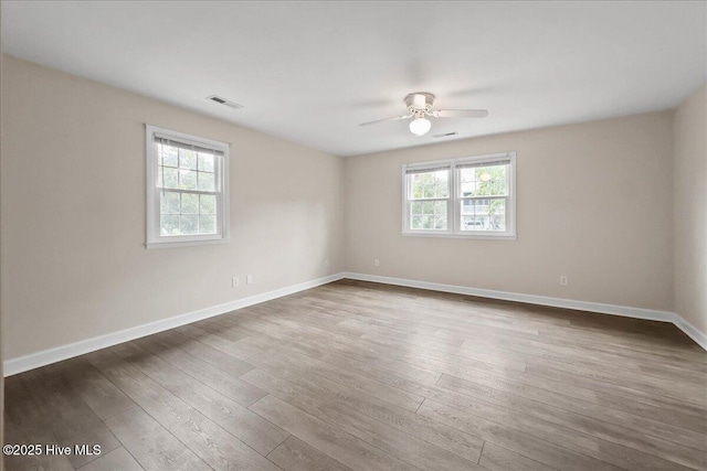 302 Mcglamery St, Oak Island, NC 28465 - empty room with a ceiling fan, dark wood-type flooring, and baseboards